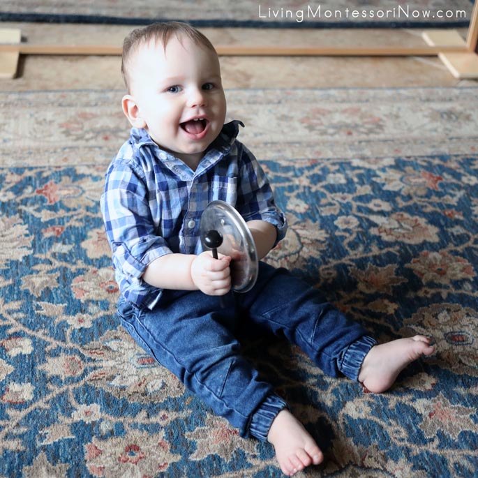 Having Fun Playing His Pot Lid Drum to a Song from Senses by Nancy Kopman