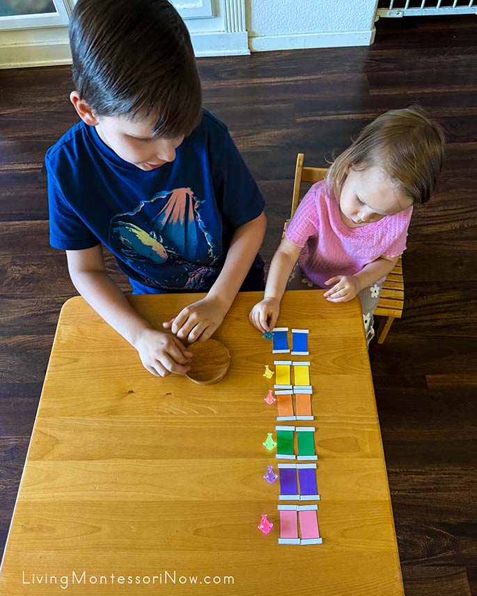 Helping His Sister Match Color Tablets to Miniature Dolphins Helping His Sister Match Color Tablets to Miniature Dolphins