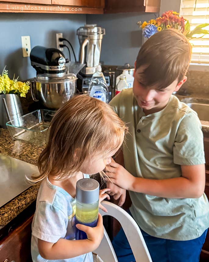 Giving His Little Sister a Layers of the Ocean Bottle Giving His Little Sister a Layers of the Ocean Bottle